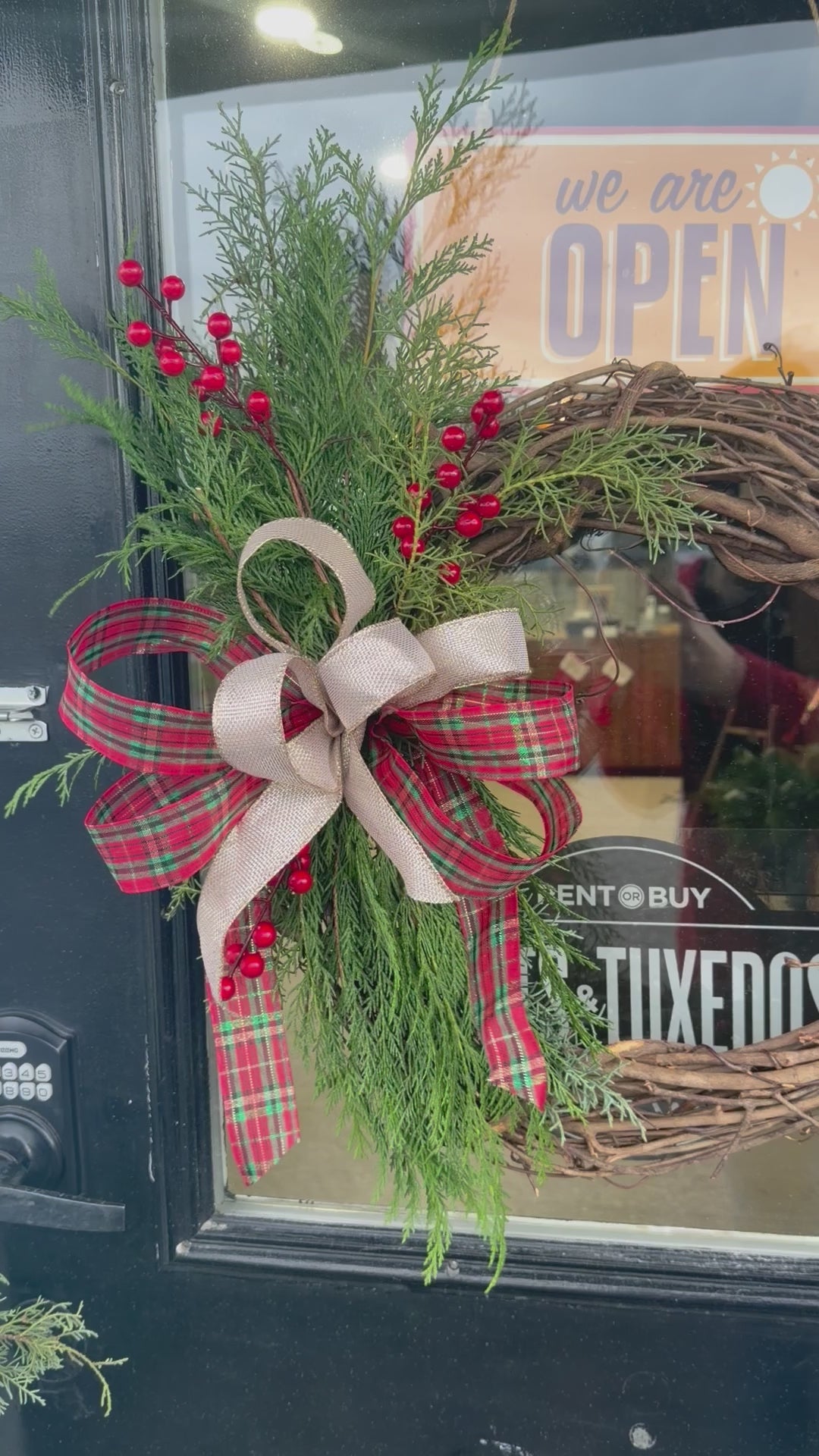 Load video: Grapevine wreath with fresh evergreen swag